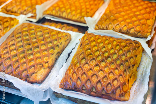 Popular Spanish Easter meat pie in the Salamanca region called Hornazo, laid out on the counter for sale in the store