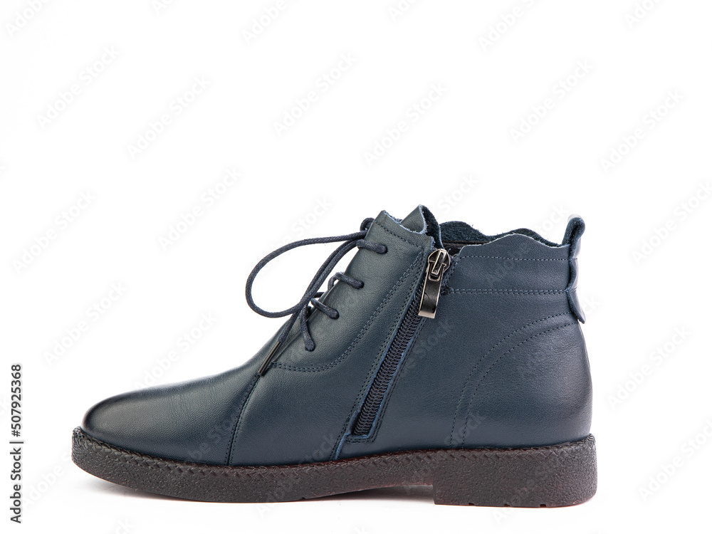 Women's autumn blue leather jodhpur boots with black sole isolated on white background. Left side view. Fashion shoes. Photoshoot for shoe shop concept.