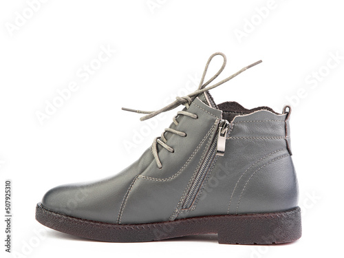 Women's autumn grey leather jodhpur boots with black sole isolated on white background. Left side view. Fashion shoes. Photoshoot for shoe shop concept.