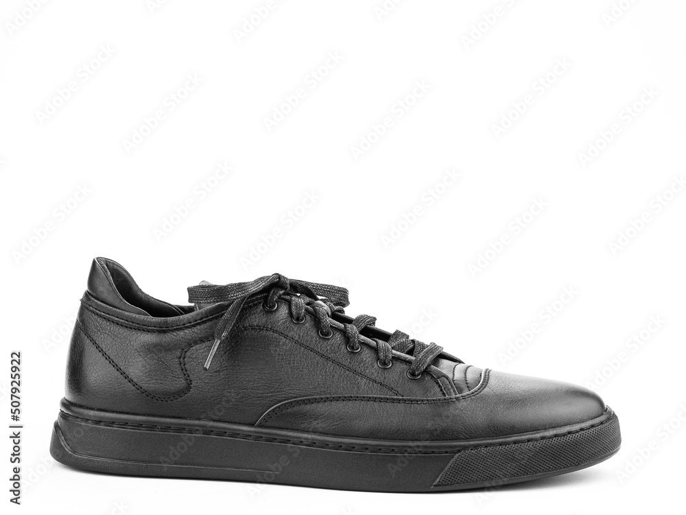 Black leather classic sneakers with laces. Casual men's style. Black rubber soles. Isolated close-up on white background. right side view. Black leather classic sneakers with laces. Casual men's style. Black rubber soles. Isolated close-up on white background. right side view.
