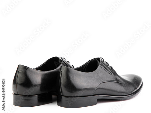 Obraz na płótnie A pair of classic leather elegant men's shoes isolated white background. Groom's stylish black shoes. Isolated object close up on white background. w salonie