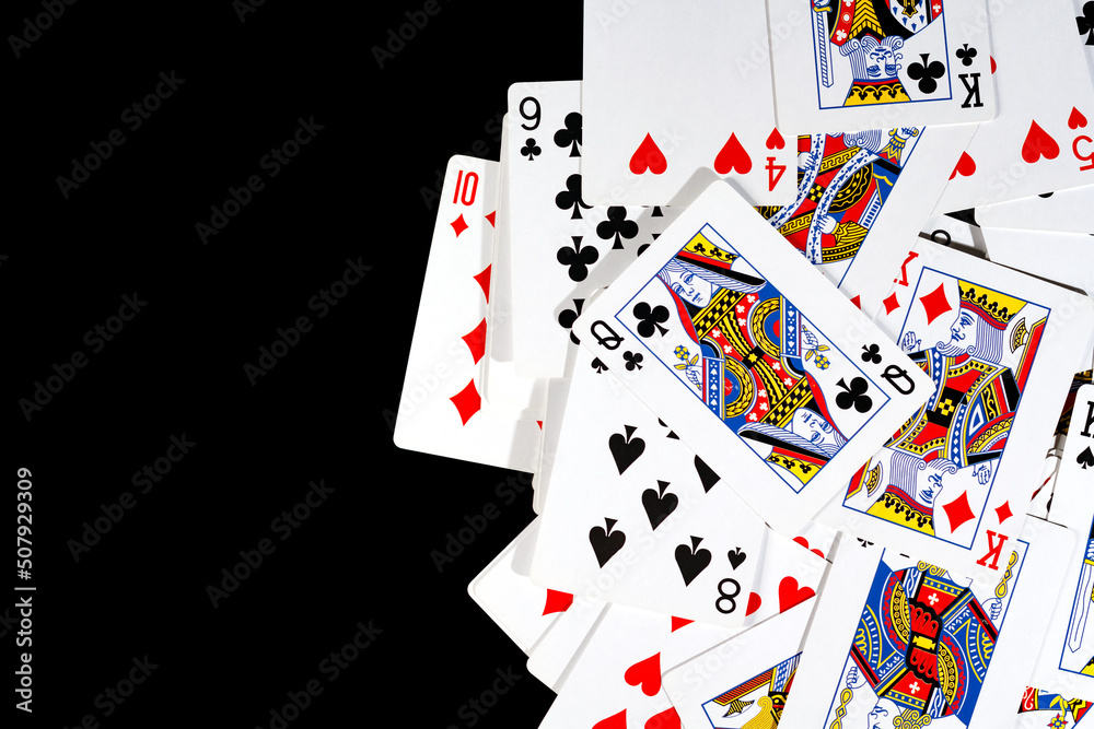 bunch of playing cards of different colors on a black background bunch of playing cards of different colors on a black background