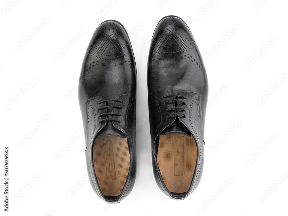 A pair of classic leather elegant men's shoes isolated white background. Groom's stylish black shoes. Isolated object close up on white background.