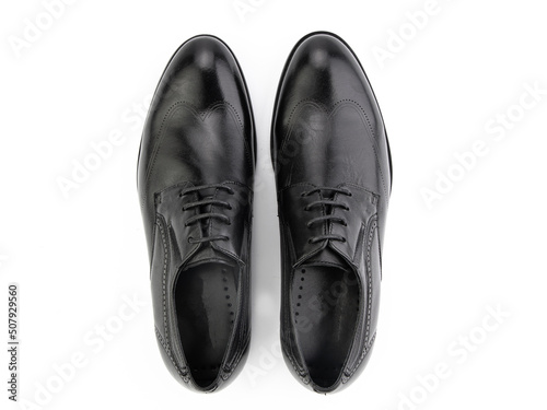 A pair of classic leather elegant men's shoes isolated white background. Groom's stylish black shoes. Isolated object close up on white background.