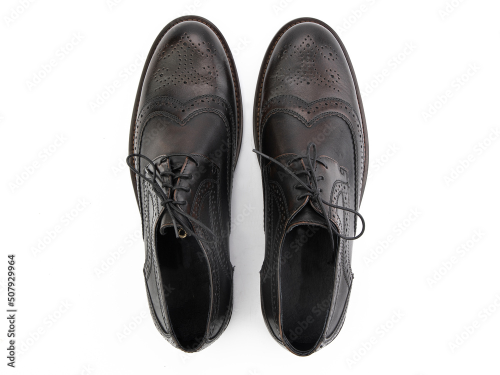 A pair of classic leather elegant men's shoes isolated white background. Groom's stylish black shoes. Isolated object close up on white background.