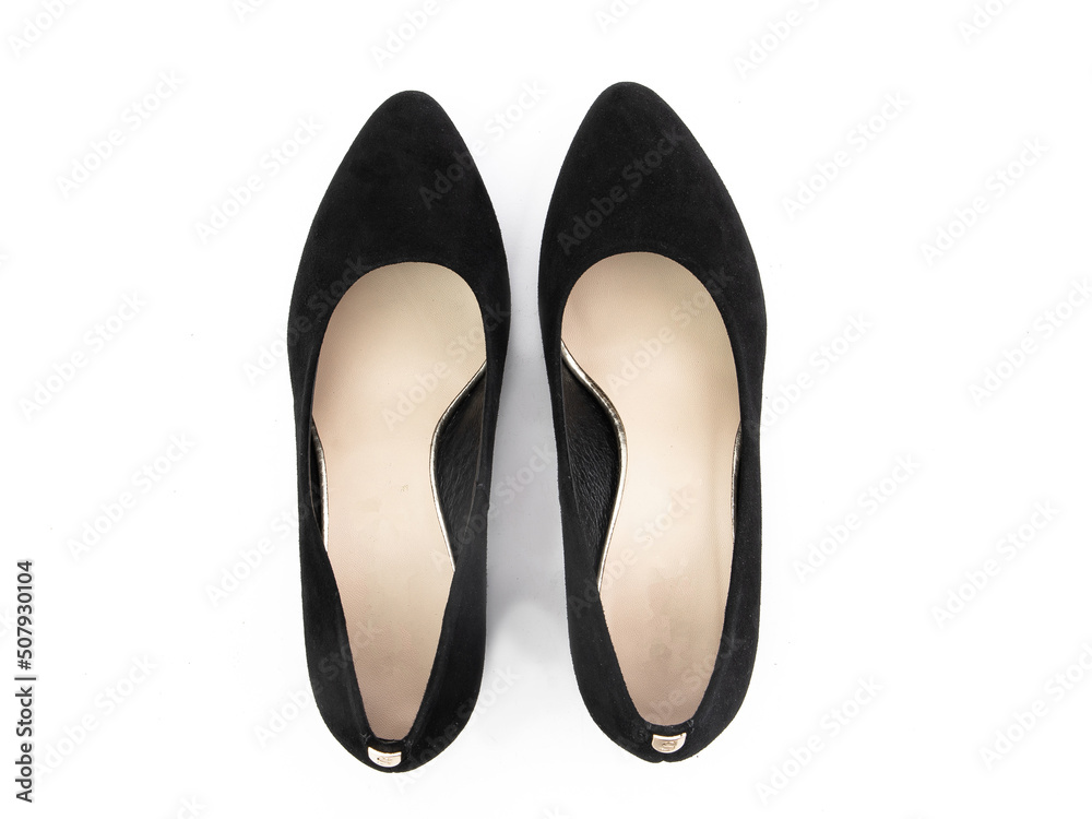 Classic and elegant high-heeled women shoes. Stylish black shoes on high thin heels and with a pointed toe. Isolated object close up on white background. Top view.