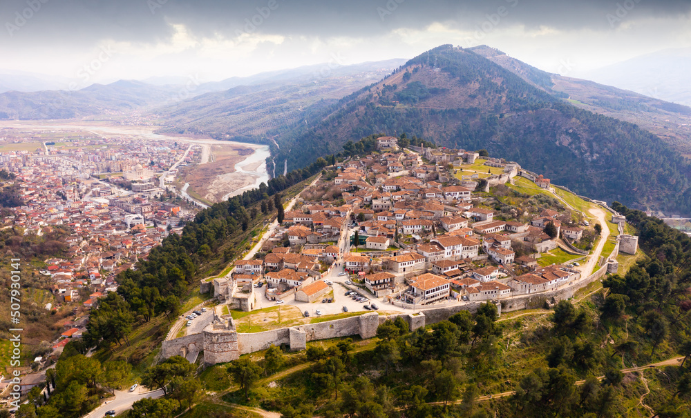 Aerial photo of Albanian city Berat with view of castle walls and tiled roofs of houses.