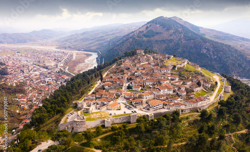 Aerial photo of Albanian city Berat with view of castle walls and tiled roofs of houses. photo