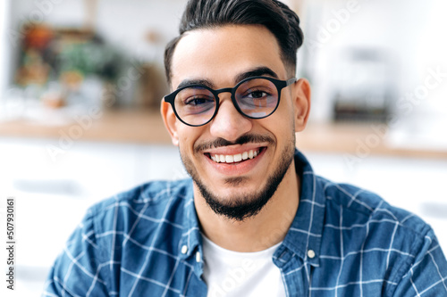 Close-up portrait of a handsome charismatic Arabian or Indian guy with glasses, Fototapet
