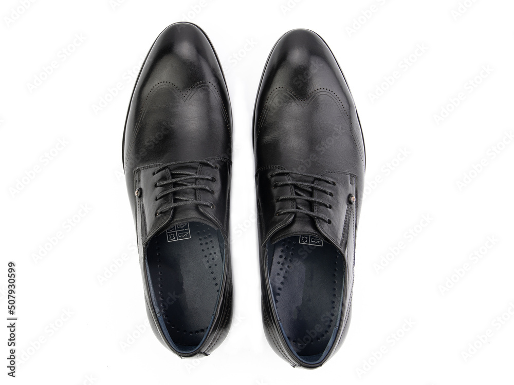 A pair of classic leather elegant men's shoes isolated white background. Groom's stylish black shoes. Isolated object close up on white background.