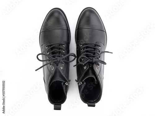 Obraz na płótnie A pair of classic leather elegant men's shoes isolated white background. Groom's stylish black shoes. Isolated object close up on white background. w salonie