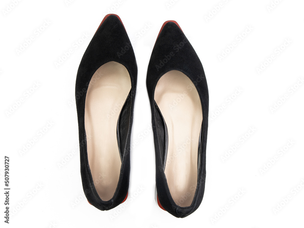 Classic and elegant high-heeled women shoes. Stylish black shoes on high thin heels and with a pointed toe. Isolated object close up on white background. Top view.