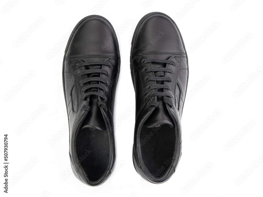 A pair of classic leather elegant men's shoes isolated white background. Groom's stylish black shoes. Isolated object close up on white background.