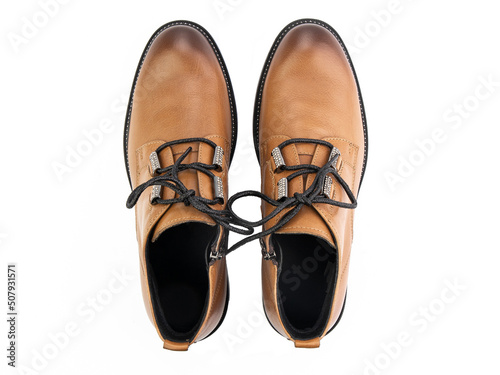 Obraz na płótnie A pair of classic leather elegant men's shoes isolated white background. Groom's stylish black shoes. Isolated object close up on white background. w salonie