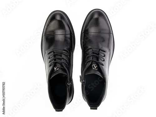 Obraz na płótnie A pair of classic leather elegant men's shoes isolated white background. Groom's stylish black shoes. Isolated object close up on white background. w salonie