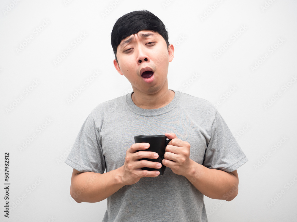 Man yawn holding coffee cup feel sleepy,Man sleepless dark circle under the eyes Man yawn holding coffee cup feel sleepy,Man sleepless dark circle under the eyes