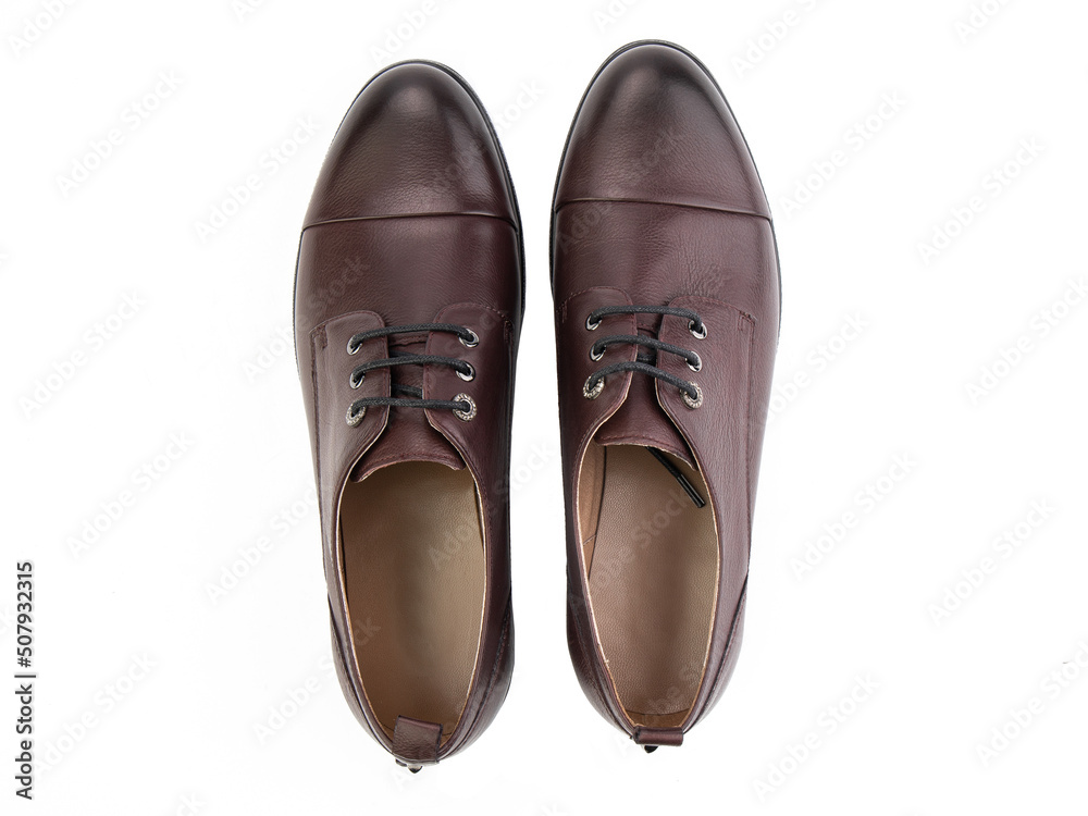 A pair of classic leather elegant men's shoes isolated white background. Groom's stylish black shoes. Isolated object close up on white background.