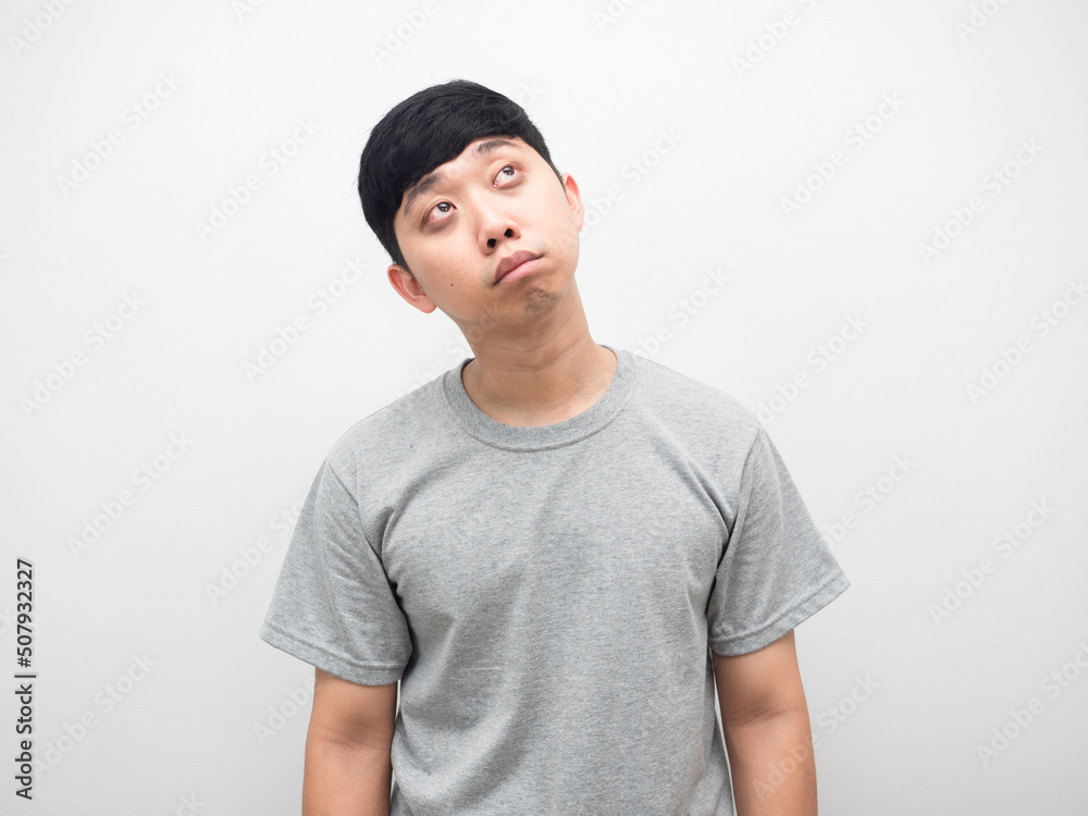 Asian man sleepless black eyes looking up at copy space Asian man sleepless black eyes looking up at copy space
