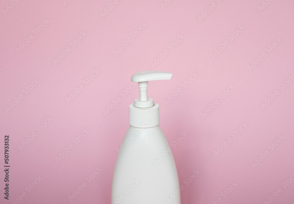 White plastic bottle with shampoo, conditioner or shower gel on a pink background. Mock up template for design. White plastic bottle with shampoo, conditioner or shower gel on a pink background. Mock up template for design.