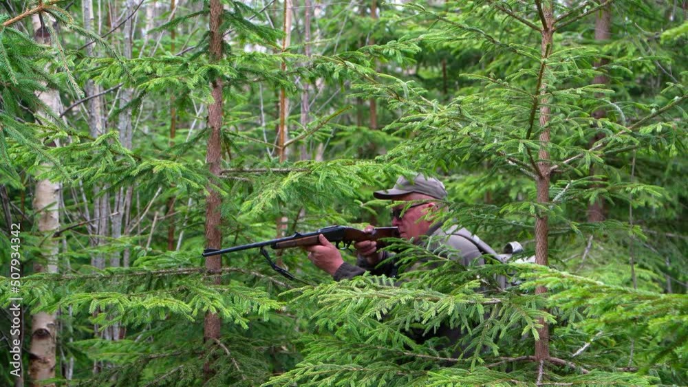 Hunter with his shotgun in middle of nature. Male hunter hunting outdoors Hunter with his shotgun in middle of nature. Male hunter hunting outdoors