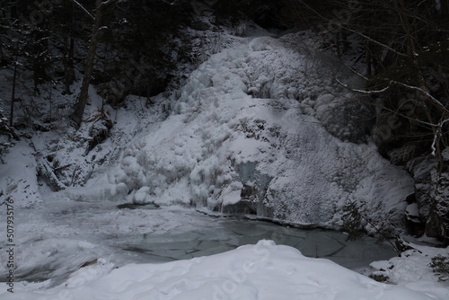 frozen winter waterfall covered in white snow