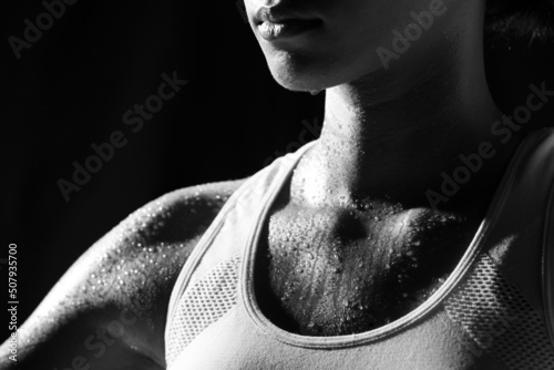 Asian Tan Skin Sport Girl in Fitness Bra, exercise sweat water drop in low key exposure lighting photo