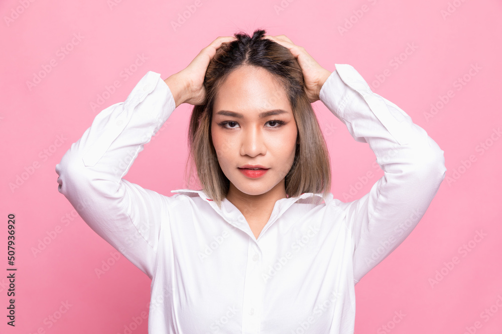 Portrait attractive asian woman feeling happy in front of a bright pink background. Portrait attractive asian woman feeling happy in front of a bright pink background.