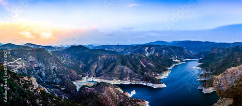 horizontal panoramic of lake surrounded of mountains in blue hour and sunrise in zimapan hidalgo  photo