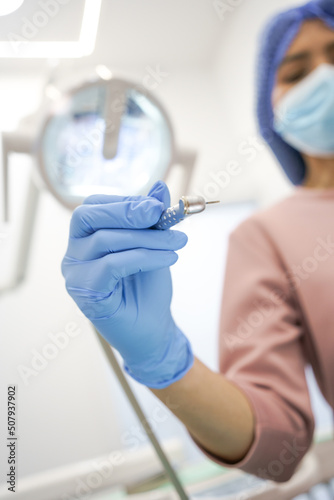 holding dental professional instruments, office interior, modern object, healthcare and treatment, hand with surgical glove photo