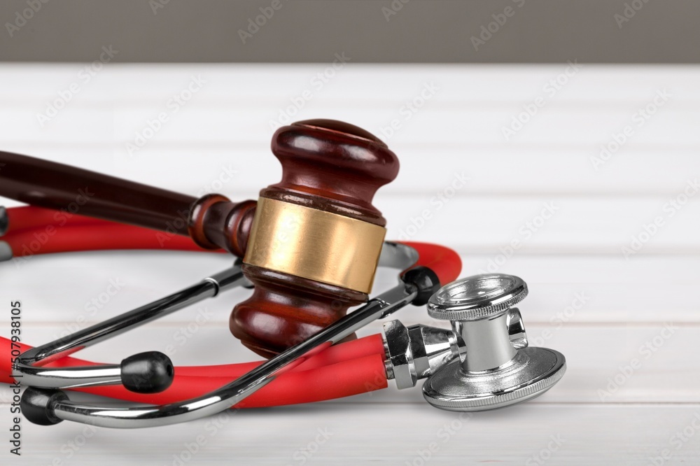 Judge gavel and medical stethoscope on wooden desk. Health and Law concept. Judge gavel and medical stethoscope on wooden desk. Health and Law concept.