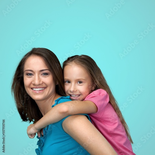 Mother's Love Concept. Portrait of happy young mom cuddling her cute tween daughter