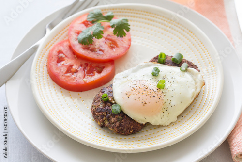 Breakfast for One Mexican Style Black Bean Cakes with Fried Eggs and Sliced Tomatoes