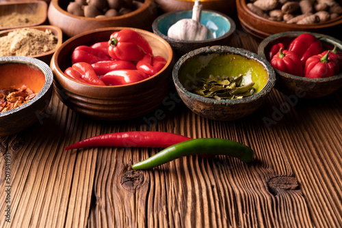 Thai food background. Ingredients in teak bowls on rustic wooden table.