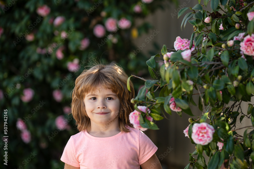 Portrait of beautiful child in the summer blossoming garden. Happy kid on the meadow with white flowers. Warm summer evening. Kids and nature. Portrait of beautiful child in the summer blossoming garden. Happy kid on the meadow with white flowers. Warm summer evening. Kids and nature.