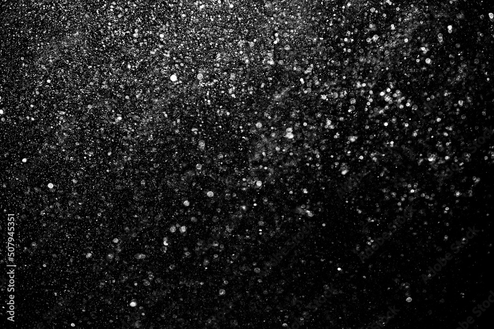 Defocused bokeh on a black background of raindrops at night