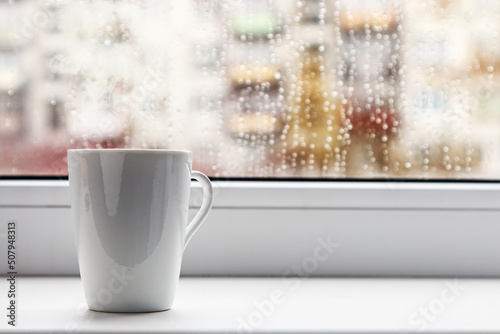 Fotografiet cup of hot coffee on the window