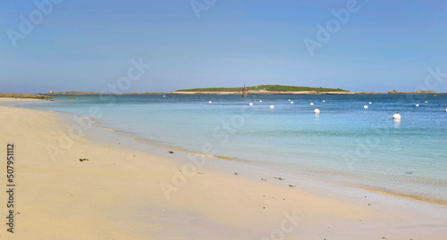 view of a beach with fine white sand and clear blue water in Brittany - France