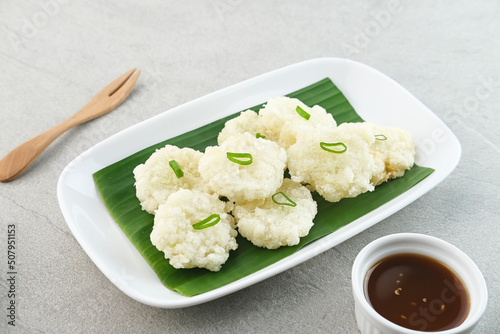 Cireng, a savory snack from West Java, Indonesia, made from tapioca flour and deep-fried, served with a spicy sauce.
 photo