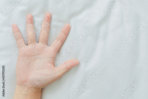 hand holding white blanket
