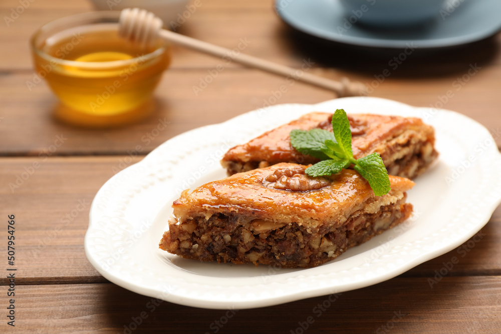 Delicious honey baklava with walnuts on wooden table, closeup Delicious honey baklava with walnuts on wooden table, closeup