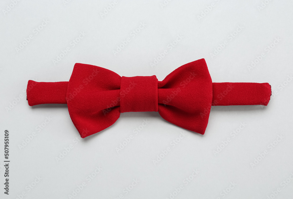 Stylish red bow tie on white background, top view