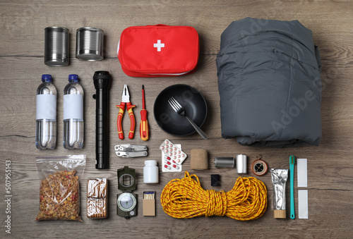Disaster supply kit for earthquake on wooden table, flat lay photo
