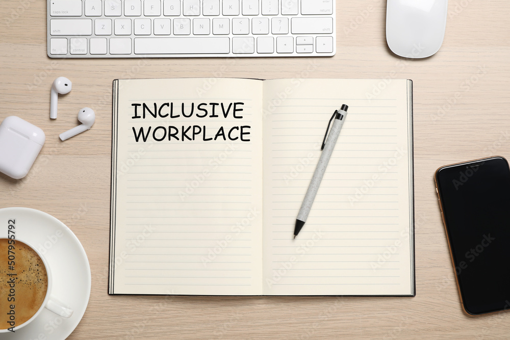 Inclusive workplace. Flat lay composition with notebook on wooden table Inclusive workplace. Flat lay composition with notebook on wooden table