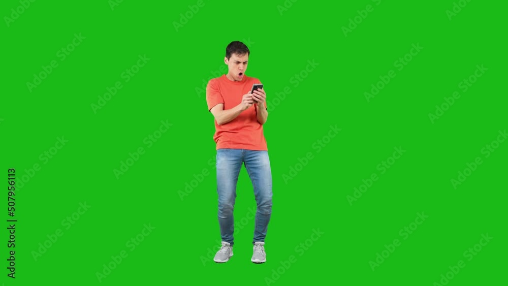 Male reading message and talking on the phone celebrating something Male reading message and talking on the phone celebrating something