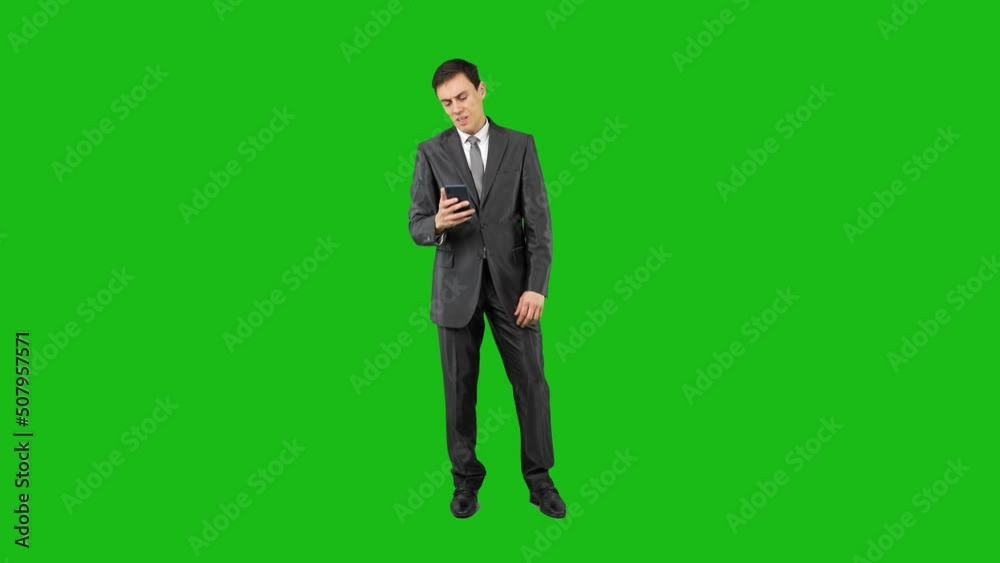 Angry businessman writing a message and talking on the phone Angry businessman writing a message and talking on the phone
