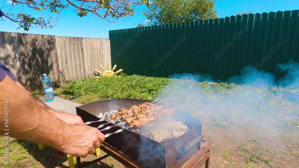 Cooking traditional Ukrainian shish kebab on the grill