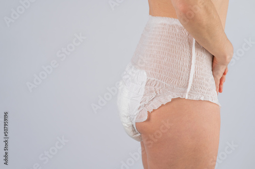 Papier peint Side view of a Woman in adult diapers on a white background