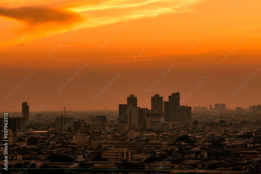 The high angle background of the city view with the secret light of the evening, blurring of night lights, showing the distribution of condominiums, dense homes in the capital community