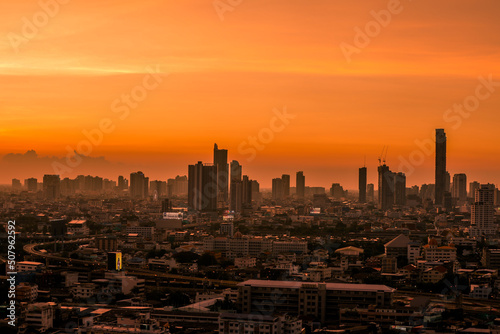 The high angle background of the city view with the secret light of the evening, blurring of night lights, showing the distribution of condominiums, dense homes in the capital community