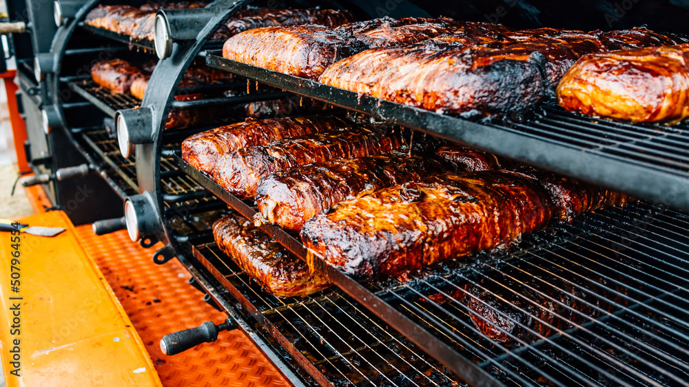 Large barbecue smoker grill with grilled meat wrapped with bacon Stock-Foto  | Adobe Stock